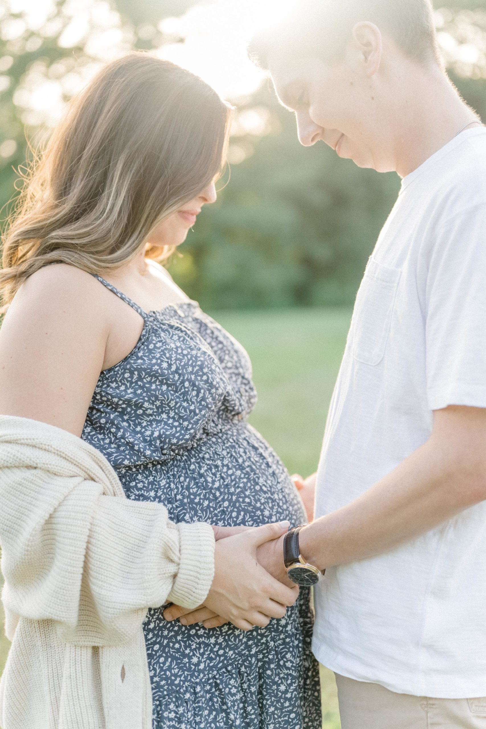 maternity session poses in an open field during sunset and golden hour.
